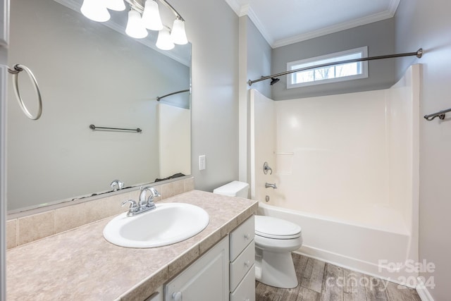 full bathroom featuring vanity, bathtub / shower combination, toilet, ornamental molding, and wood-type flooring