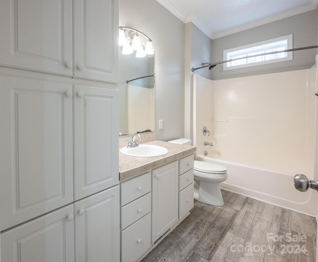 full bathroom with hardwood / wood-style flooring, vanity, tub / shower combination, and crown molding