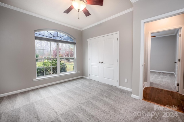 unfurnished bedroom with a closet, ceiling fan, and ornamental molding