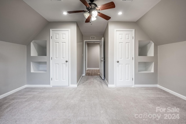 bonus room with light colored carpet and vaulted ceiling