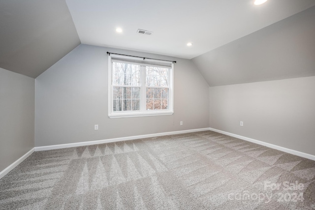 additional living space with carpet and vaulted ceiling