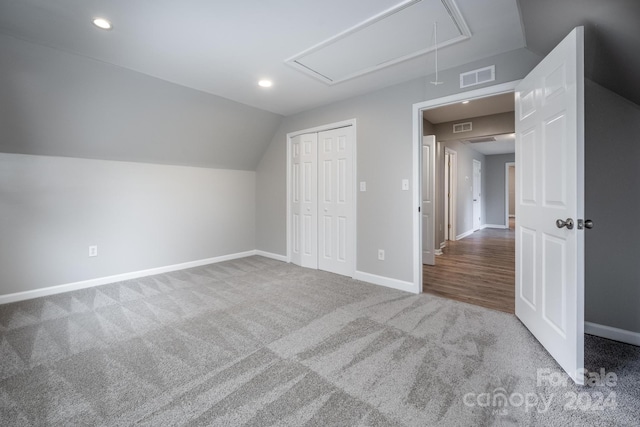 bonus room with carpet floors and vaulted ceiling