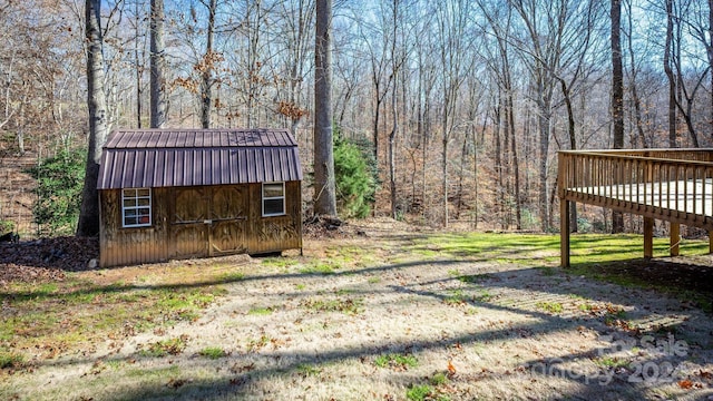 view of yard featuring a storage shed and a deck