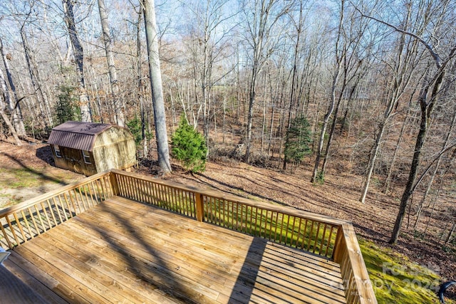 wooden deck with a storage shed