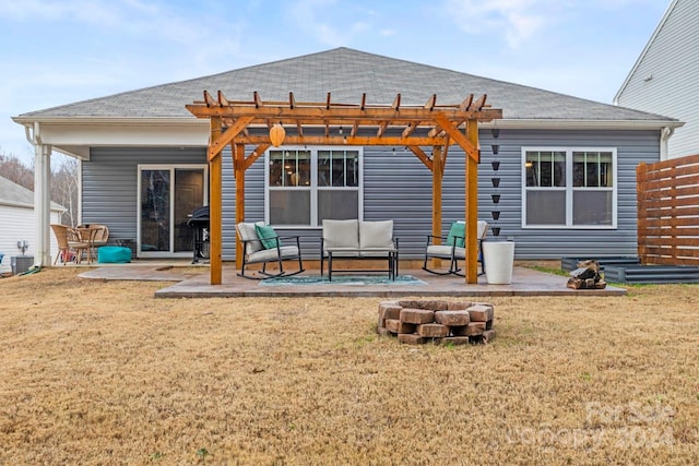 rear view of property with a pergola, outdoor lounge area, a patio area, and a lawn