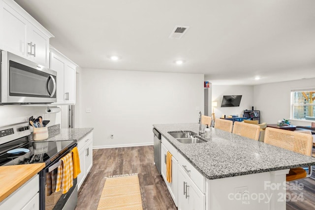 kitchen with white cabinetry, sink, a center island with sink, and appliances with stainless steel finishes