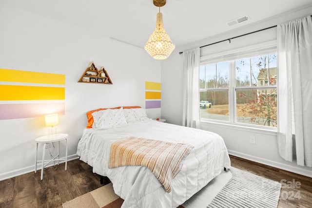 bedroom with dark hardwood / wood-style flooring