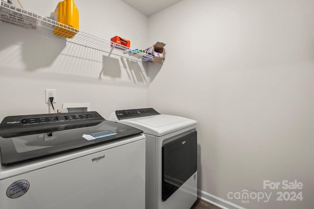 clothes washing area with washing machine and dryer