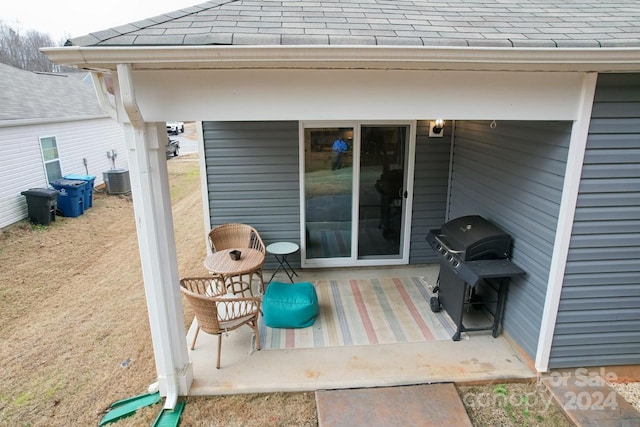 view of patio / terrace with central AC unit and a grill