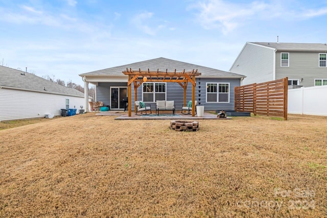 back of property featuring a pergola, a yard, and an outdoor living space with a fire pit