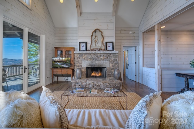 living room with a stone fireplace, wood walls, high vaulted ceiling, and wood-type flooring