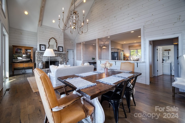 dining area with washer / clothes dryer, wooden walls, high vaulted ceiling, a fireplace, and dark hardwood / wood-style floors