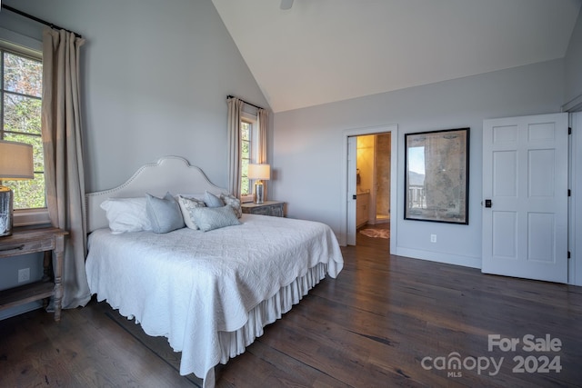 bedroom with high vaulted ceiling, dark wood-type flooring, and connected bathroom