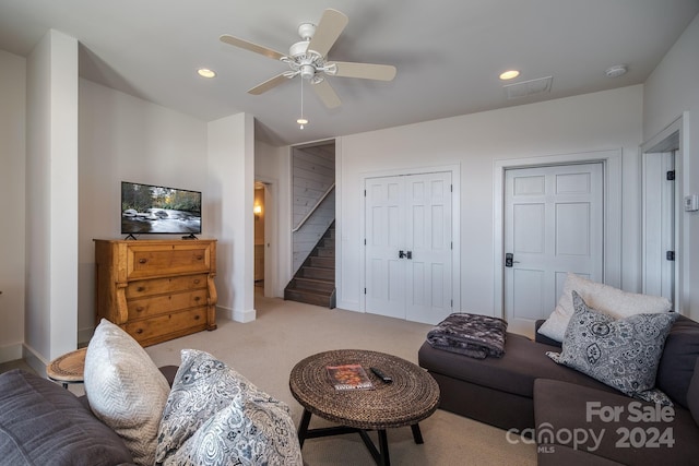 living room featuring carpet and ceiling fan