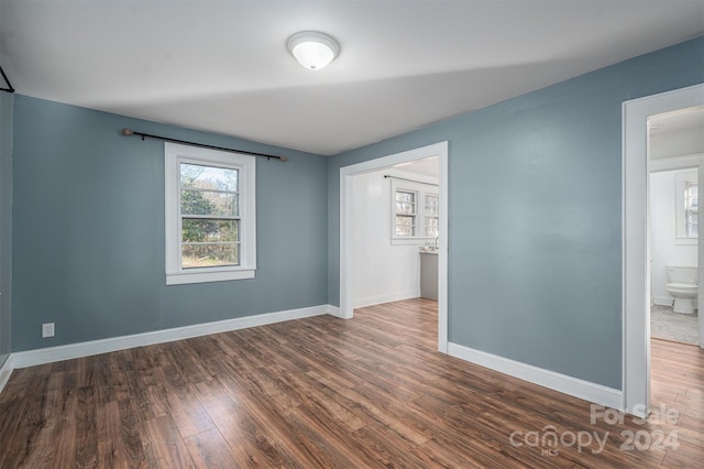 spare room with dark wood-type flooring