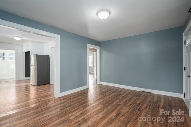 interior space with dark hardwood / wood-style floors and a wealth of natural light