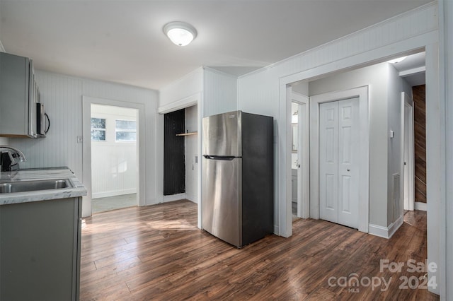 kitchen with gray cabinets, dark hardwood / wood-style flooring, and appliances with stainless steel finishes