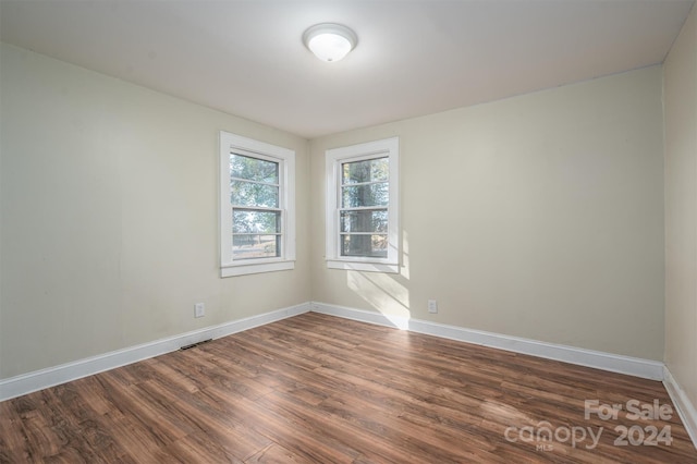 spare room with dark wood-type flooring