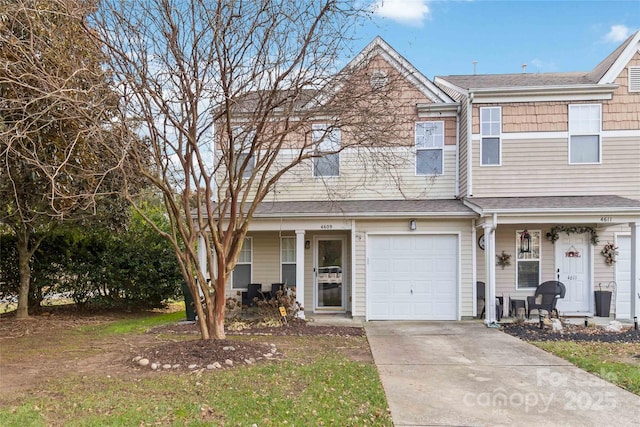 multi unit property with covered porch, roof with shingles, and driveway