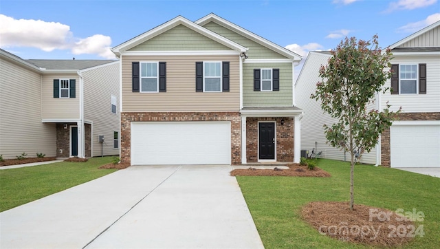 view of front of property featuring a front yard and a garage