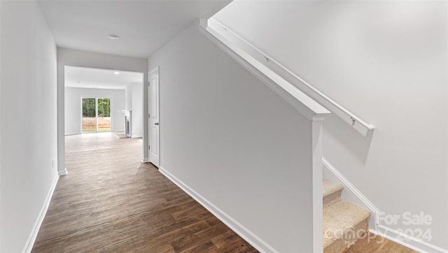 hall with dark wood-type flooring