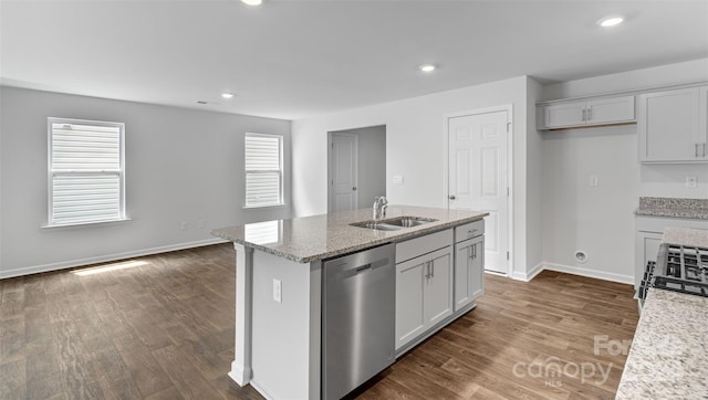 kitchen featuring light stone counters, sink, a center island with sink, dishwasher, and dark hardwood / wood-style floors