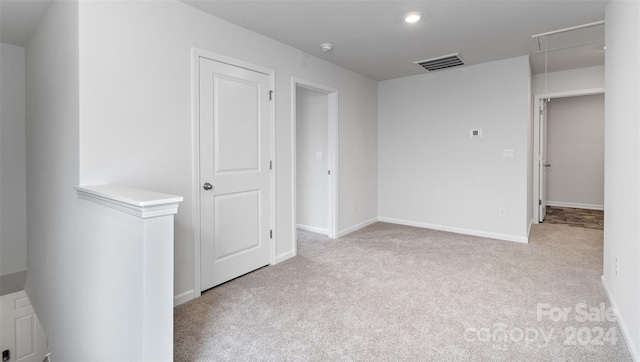 spare room with light colored carpet