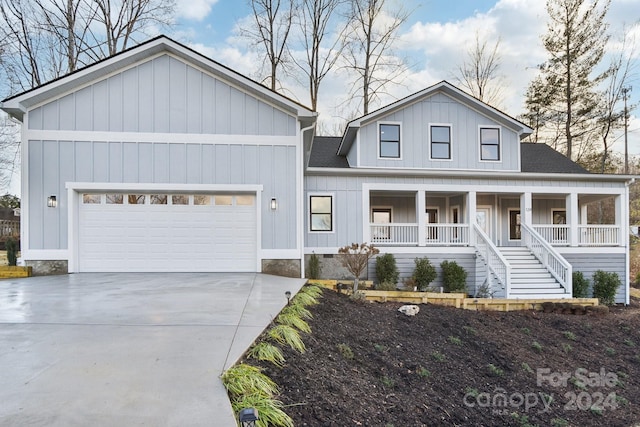 view of front of property featuring a porch and a garage