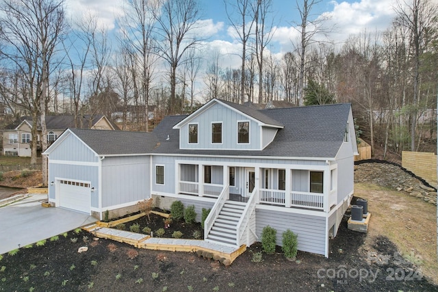 view of front of home featuring a garage, covered porch, and central AC