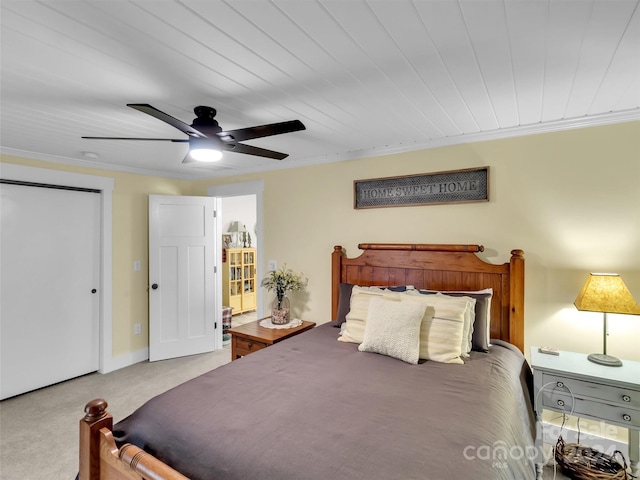 carpeted bedroom featuring ceiling fan, crown molding, and wood ceiling