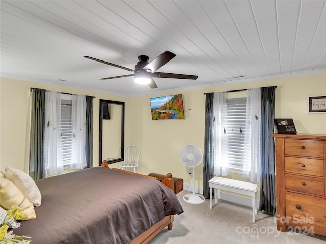 bedroom featuring ceiling fan, light colored carpet, wooden ceiling, and crown molding