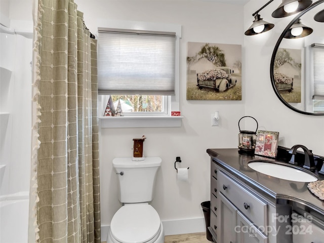 bathroom with a shower with curtain, vanity, toilet, and wood-type flooring