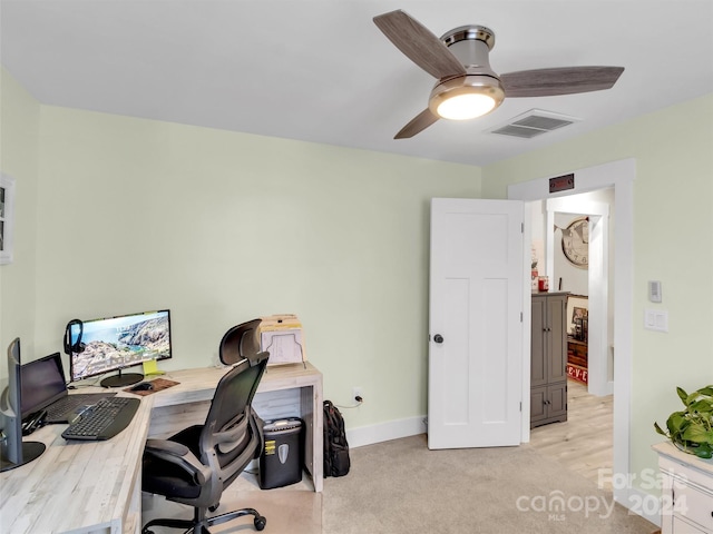 carpeted office featuring ceiling fan