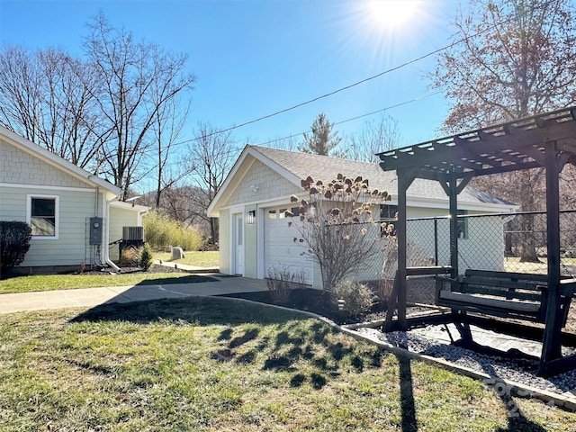 view of home's exterior featuring a pergola, a yard, central AC, a garage, and an outdoor structure