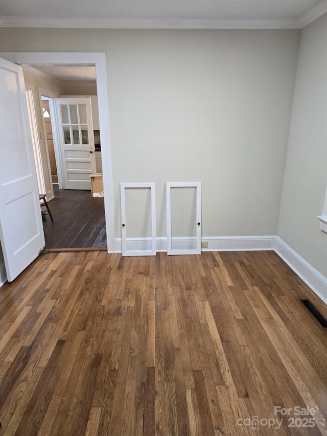 spare room with dark hardwood / wood-style floors and ornamental molding