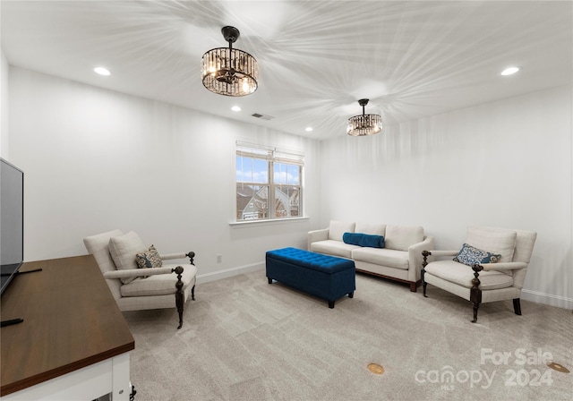 living room with light carpet and an inviting chandelier