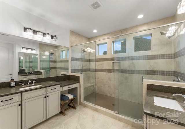 bathroom featuring vanity and a shower with shower door