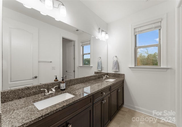 bathroom featuring tile patterned flooring and vanity