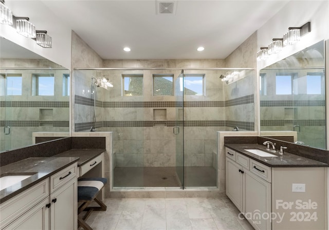 bathroom with tile patterned floors, vanity, and a shower with shower door