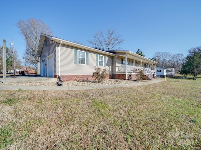 ranch-style house with a front lawn, covered porch, and a garage