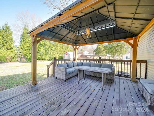 wooden deck with outdoor lounge area, a gazebo, a yard, and a shed