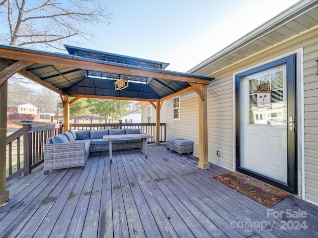 wooden terrace with a gazebo and an outdoor hangout area