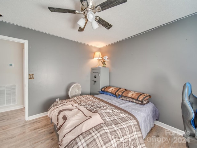 bedroom featuring light wood-type flooring and ceiling fan