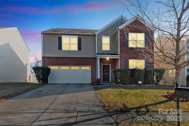 front facade featuring a garage and a yard