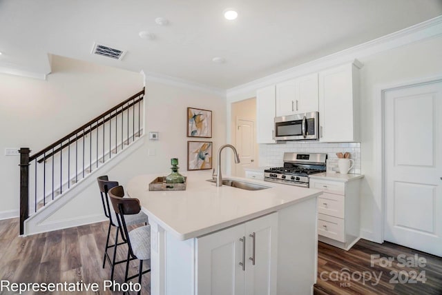 kitchen featuring white cabinetry, sink, and appliances with stainless steel finishes