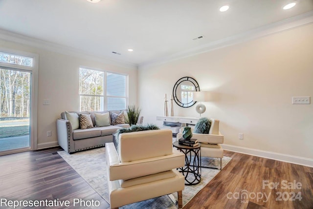 living room featuring hardwood / wood-style flooring and ornamental molding