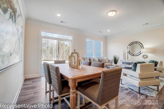 dining area featuring dark hardwood / wood-style flooring and ornamental molding