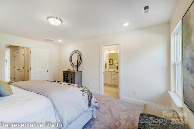 carpeted bedroom with ensuite bathroom