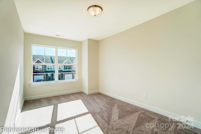 unfurnished room with light carpet