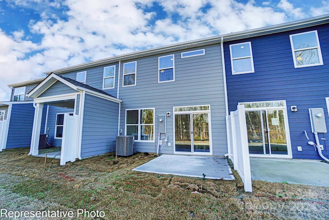 back of property with a patio and central AC